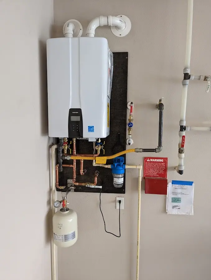 Professional plumber installing copper piping in a Oglesby home